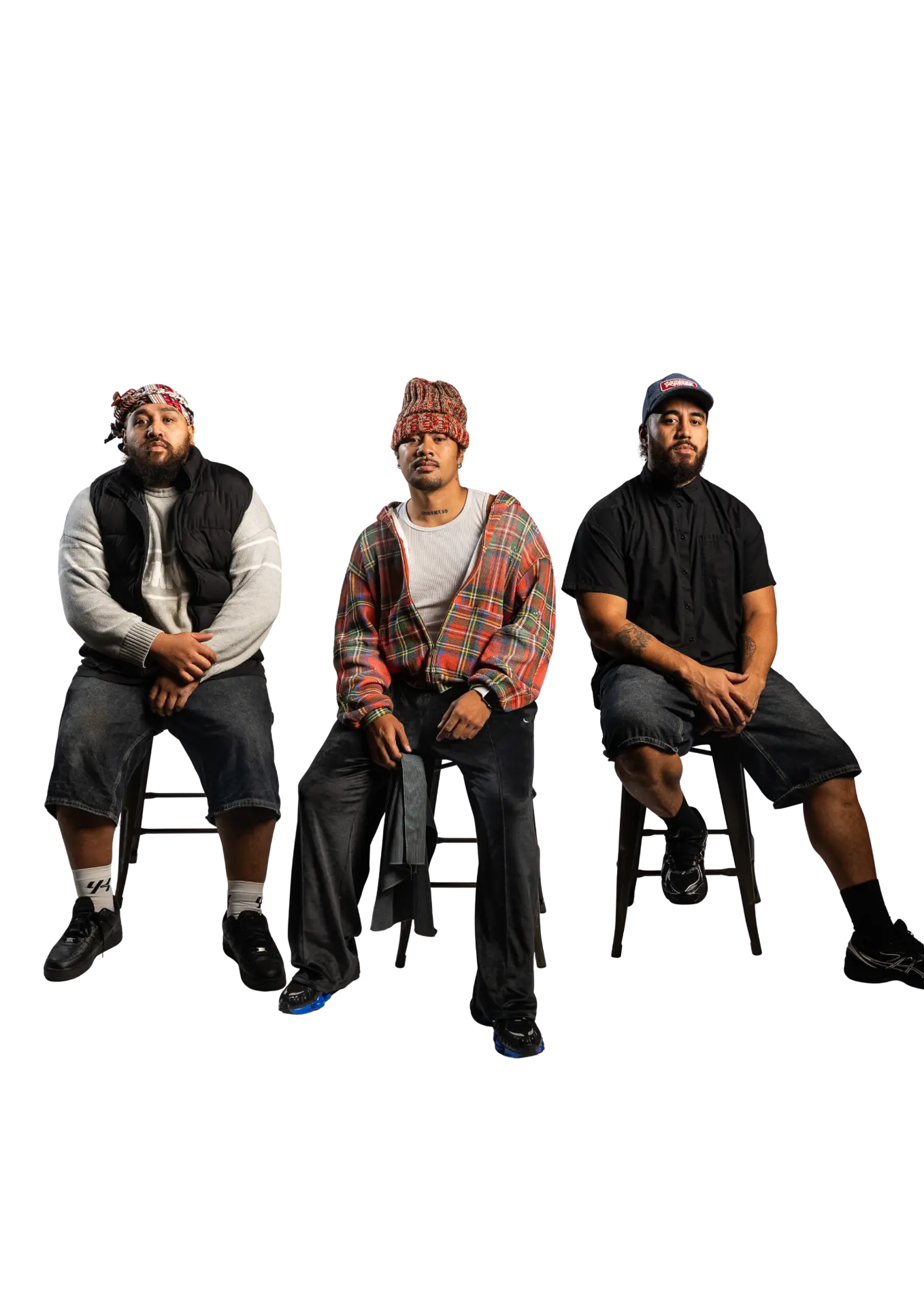 The three members of Planet Vegeta seated on stools against a black background